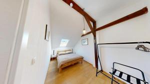 a room with a bed and a chair in it at Marktplatz Traunsee LAKE View in Gmunden
