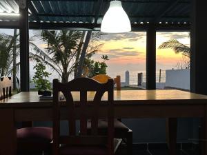 a dining room table with a view of the ocean at Tuktuk Cabanas in Negombo