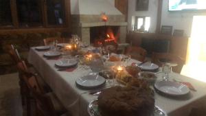 a table with a white table cloth and candles on it at Вила НАДЕЖДА in Byala