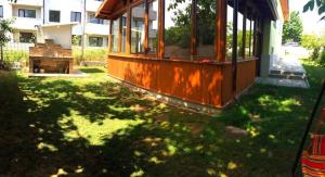 a house in a yard with a grassy yard with a building at Вила НАДЕЖДА in Byala +6 photos