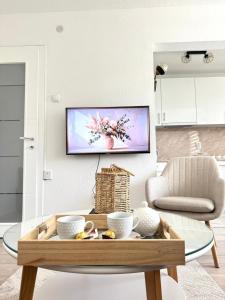 a living room with a tv on a wall at Apartman Gold Jajce in Jajce