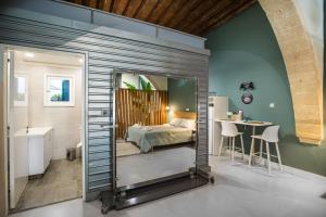 a bedroom with a bed and a table and a mirror at Atelier Residences by Sweet Keys in Limassol