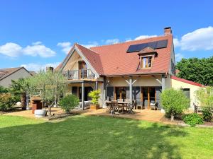 a house with a deck and a patio at VILLA XXL - SPA & Cuisine d'été in Viarmes