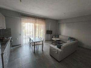 a living room with a couch and a table at Irina's Apartment 5 in Psakoudia