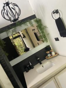 a bathroom with a sink and a mirror at Cabaña Lambrusco - La Cava Lodge in Medellín