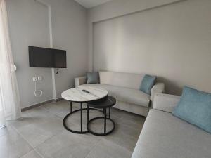 a living room with a couch and a table at Irina's Apartment 5 in Psakoudia