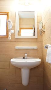 a bathroom with a white sink and a mirror at Campanitx Villas - Astbury Formentera in Es Calo