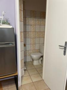 a small bathroom with a toilet and a television at UPaniAni in Ustronie Morskie +25 photos
