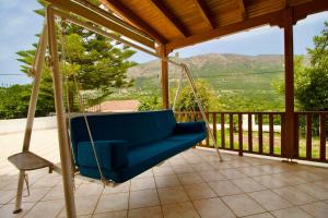 a swing on a porch with a view at Villa Joya in Makriótika