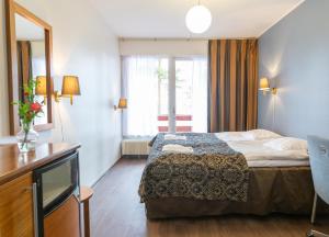 a hotel room with a bed and a window at Keurusselkä Resort in Keuruu +71 photos