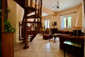 a living room with a spiral staircase in a living room at Villa Joya in Makriótika +28 photos