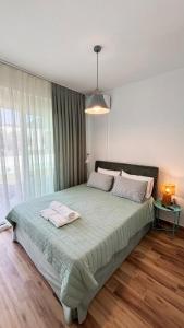 a bedroom with a large bed with two towels on it at Vagia's House in Skala Rachoniou +19 photos
