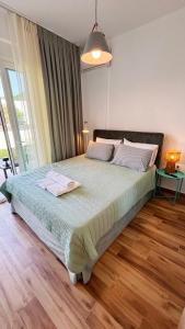 a bedroom with a large bed with two towels on it at Vagia's House in Skala Rachoniou