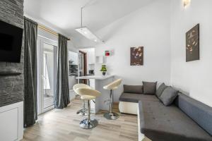 a living room with a couch and a table at Apartments 2 with pool and private jacuzzi in Vodice