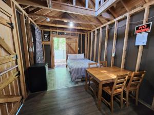 a room with a table and a bed and a no smoking sign at Oakhill Pines Campground in Bridgewater