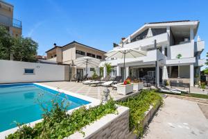 an exterior view of a house with a swimming pool at Apartments 2 with pool and private jacuzzi in Vodice