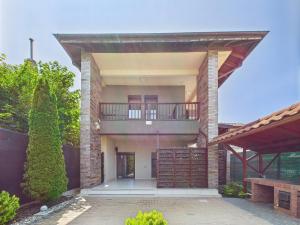 a large house with a balcony on top of it at Casa Pontica in 2 Mai