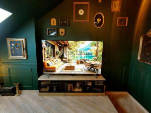 圣洛LES CLES DES REMPARTS - Appartement privé à thème tout équipé - Atypique - Centre Saint-Lô - Gare - Haras - Parking public gratuit - Entrée autonome - Wifi - Netflix - TV XXL - Lit 160x200的客厅设有绿色的墙壁和桌子