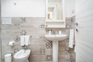 a bathroom with a sink and a toilet at GARDEN HOUSE: APARTMENTS AND ROOMS FOR HOLIDAYS in Palermo +75 photos