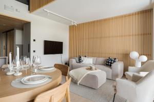 a living room with a couch and a table at Auroras by Kaltios, Gielas, Ski-in Ski-out, Mountain view in Kittilä