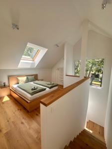 a bedroom with a bed and two windows at Sitara's Chalet in Bled