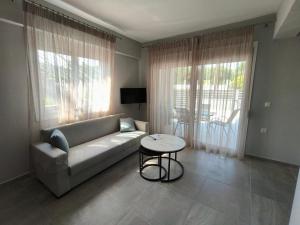 a living room with a couch and a table at Irina's Apartment 6 in Psakoudia