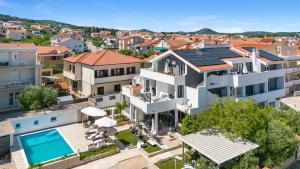 an aerial view of a house with a swimming pool at Apartments 2 with pool and private jacuzzi in Vodice