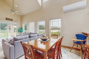 a living room with a table and a couch at Lake Front Townhome - Rockaway Beach in Rockaway Beach
