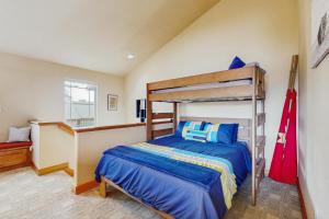 a bedroom with a bunk bed with blue sheets at Lake Front Townhome - Rockaway Beach in Rockaway Beach