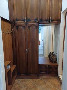 a large wooden cabinet with a window in a room at Demjén ház in Nyíregyháza
