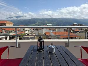 a bench on a balcony with a view of a city at Aggelos Elegant Stay City Center in Ioannina