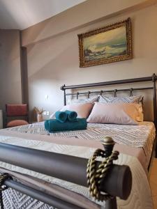 a bedroom with a bed with blue towels on it at Aggelos Elegant Stay City Center in Ioannina