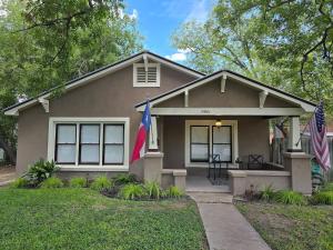 a house with two flags in front of it at Craftsman by Downtown Uvalde in Uvalde
