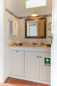 a bathroom with a sink and a mirror at Vila Mar Beach House in Arcozelo