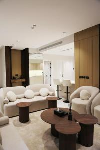 a living room with two couches and tables in it at Luxury apartment ALMajdiah Residence 3Q7 Boulevar البوليفارد in Riyadh