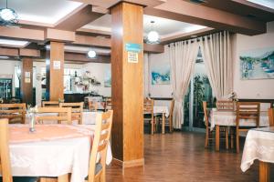 a dining room with white tables and chairs and tablesearcher at Hotel Skrapari in Çorovodë