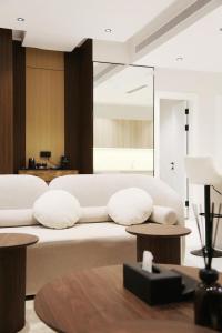 a living room with a large white couch with pillows at Luxury apartment ALMajdiah Residence 3Q7 Boulevar البوليفارد in Riyadh +21 photos