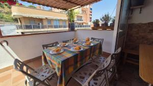 a table with plates of food on a balcony at Ático, terraza y Barbacoa in Barcelona