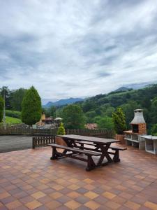 a picnic table on a patio with a view at Casa Liron in Corao