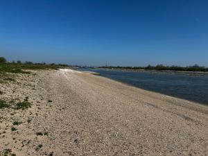 een onverharde weg naast een waterlichaam bij Uilehoeve aan de Waal in Zennewijnen