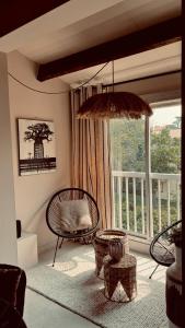 a living room with a chair and a large window at Nid douillet pour vos vacances ! in Fréjus