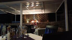 a dining room with a table and chairs and a wall with at Resort Village T.N. Milna in Vis