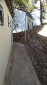 a sidewalk in front of a white building at Resort Village T.N. Milna in Vis