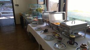 a buffet line with some food on a table at Resort Village T.N. Milna in Vis