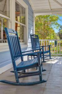 two blue rocking chairs sitting on the porch of a house at Wine Country Retreat with Pool & Hot Tub - Dogs OK in Guerneville
