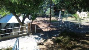 a fence next to a tree next to a building at Resort Village T.N. Milna in Vis
