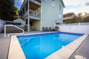 a swimming pool in front of a house at Private Pool Spa & Spacious Deck in Corolla