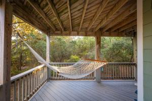 a hammock on the porch of a cabin at Private Pool Spa & Spacious Deck in Corolla