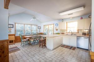 a kitchen and dining room with a table and chairs at Private Pool Spa & Spacious Deck in Corolla