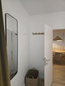 a door to a room with a mirror and a table at Topgelegen Appartement Alma in Antwerp +11 photos